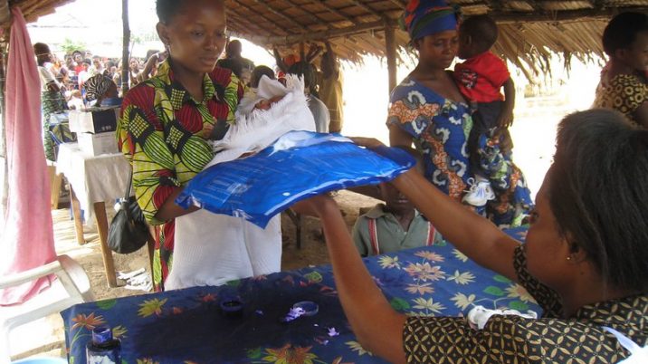 malaria net handed over to woman