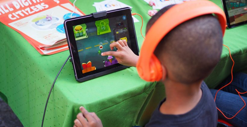 little boy playing educational game on ipad