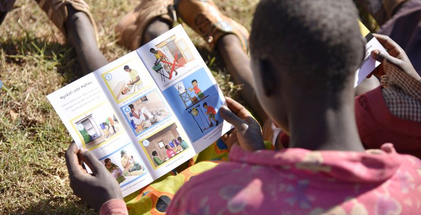 girl reading material about handwashing