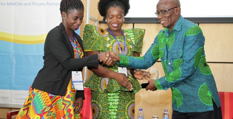 man congratulating woman at prize award