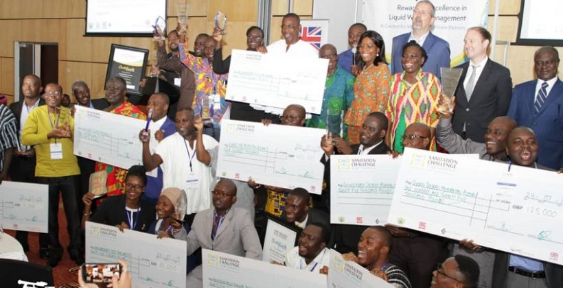 group photo with people holding their prize winning cheques