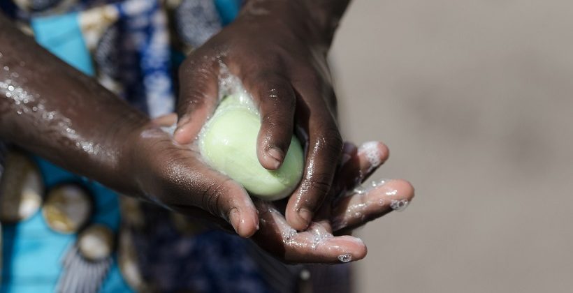 African Girl Washing Hands with Soap and Water