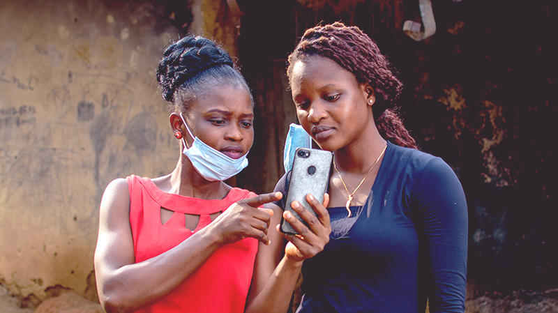 Two women look at a phone